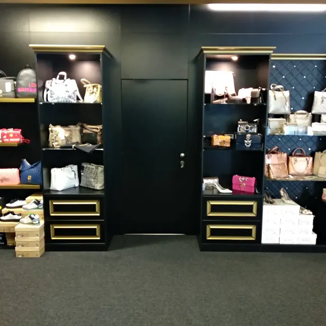 Butik — čierne regály so zlatými detailmi